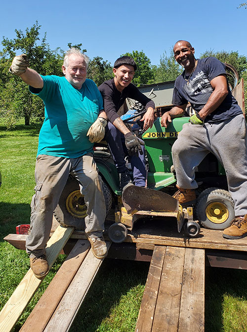 men resting on tractor